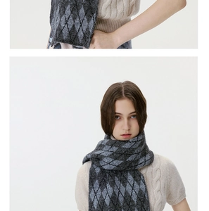 Macro shot of argyle knit pattern and soft wool texture on gray black winter scarf