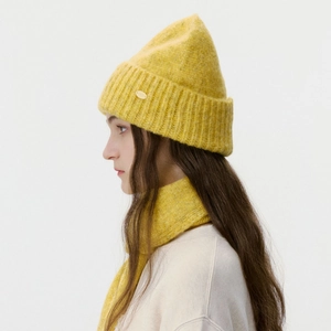 Yellow knitted hat and scarf set for winter featuring thick ribbed texture and gold logo