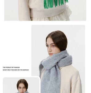 Detailed close-up of soft grey and green mohair scarves featuring classic long fringe tassels