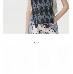 Detail of gray diamond pattern knitted scarf with soft thick texture and bicolor finish