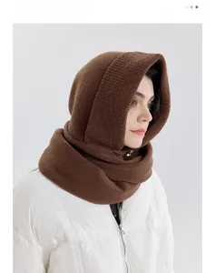Close-up of dark brown knitted balaclava showing thick ribbed texture and warm yarn fabric