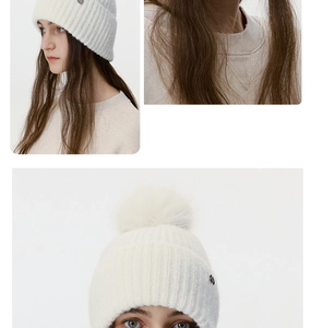 Detail showing soft knit texture and fluffy faux fur pompom on this winter beanie