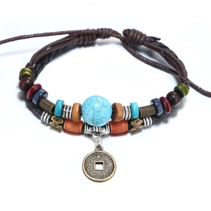 Bohemian multilayer bracelet with turquoise beads and antique bronze coin charm on white back