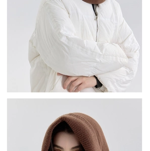 Detail of coffee brown knit balaclava paired with a white quilted puffer jacket for winter