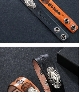 Dettaglio del bracciale in pelle retrò con fibbie in metallo e motivi totem in rilievo