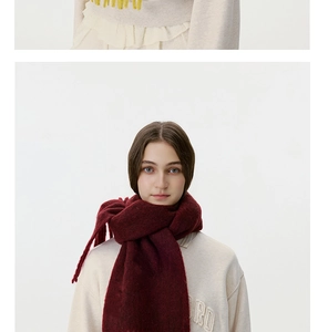 Close-up of thick wine red knit scarf with fringe tassels for winter warmth