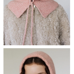 Detail of pink ribbed knit balaclava hood paired with a cream fleece faux fur jacket