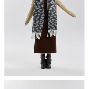 Detail of leopard print fringe scarf paired with beige top and dark brown skirt outfit