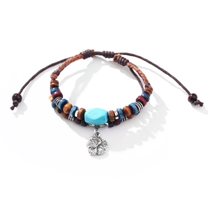 Bohemian braided bracelet with colorful beads, turquoise stone, and metal flower charm