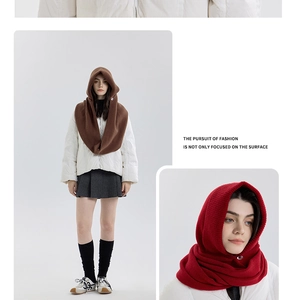 Detail view of knitted balaclava hood scarves in brown and red with button closure