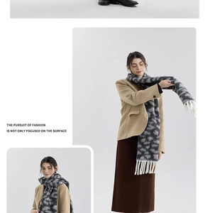Detail view of retro leopard print scarf with woven texture and long white tassel trim