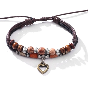 Bohemian braided leather bracelet with vintage heart pendant and exotic wooden beads