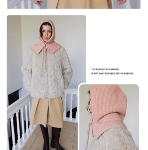 Detailed view of a pink knitted balaclava hood with tie straps and soft texture detail