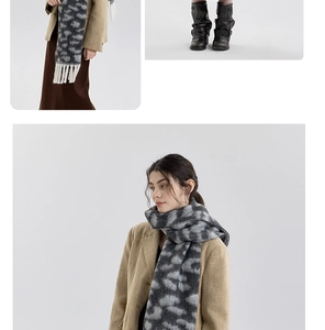 Close-up of soft thick leopard print scarf with white fringe details and kitted textures