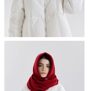 Detailed view of dark red knit balaclava with button fastener and white winter jacket