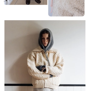 Detailed knit texture of off-white cable knit hooded scarf with matching grey accessories