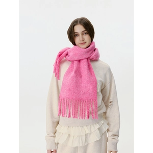 Classic pink knitted scarf with elegant long fringes for a warm minimalist winter look