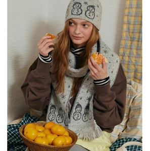 Detail of light gray knit hat and scarf set with jacquard snowman pattern and soft fringes