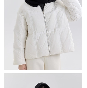 Detailed view of white quilted down jacket with metal zipper and soft fabric texture