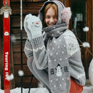 Winter wool blend hooded scarf and snowman pattern gloves set in outdoor snowy scene