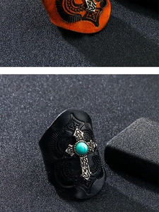 Macro detail of wide leather ring featuring vintage cross and turquoise stone inlay