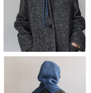 Detail of blue knitted balaclava hood paired with retro black and white herringbone coat