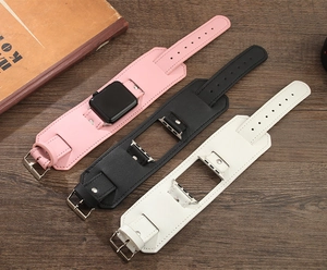 Three wide leather watch bands for Apple Watch in pink black and white on wooden background