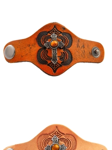 Detail of vintage leather bracelets with embossed cross and tiger eye stone inlay