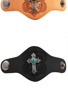 Detail of vintage leather bracelets with metal cross and center turquoise inlay