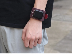 Wide leather Apple Watch strap in wine red with litchi texture and rivet button on wrist