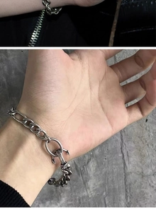 Close-up of vintage silver Cuban chain bracelet with anchor clasp and industrial finish