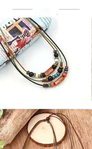 Detail of vintage bohemian multilayer necklace with colorful wooden beads and adjustable cord