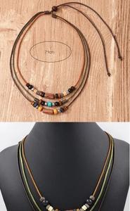 Detail of bohemian multilayer necklace with wooden beads and turquoise accents, length 71cm