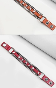 Dettaglio di bracciali punk in pelle con borchie a stella e catene metalliche