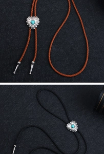 Detailed view of punk bolo tie heart pendant with turquoise stone and woven ropes