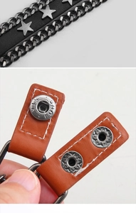 Dettaglio del bracciale punk in pelle con borchie a stella ed elementi a catena in metallo