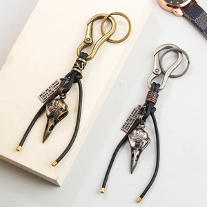 Retro bird skull keychain with leather cord and engraved plaque in bronze and silver