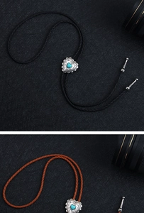 Detail of heart-shaped turquoise bolo tie pendant with vintage metallic engravings