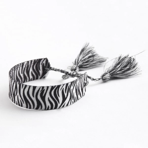 Handmade zebra pattern woven bracelet with bohemian tassels and adjustable sliding closure