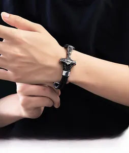 Close-up of Viking Mjölnir pendant on black braided leather bracelet with magnetic clasp