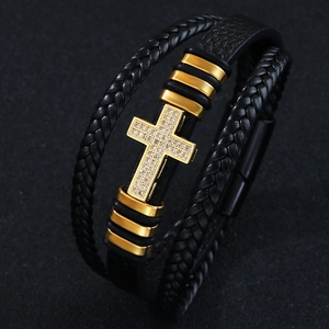 Braided black leather bracelet with golden zircon cross pendant in a stylish layered design