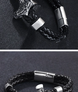 Detail of Thor's Hammer charm on a black braided leather bracelet with magnetic clasp