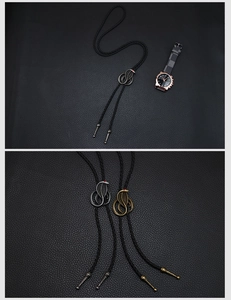 Detailed view of braided leather bolo tie with 3D cobra metal slider and red crystal eyes