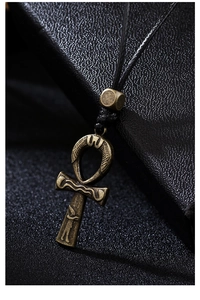 Macro shot of vintage bronze Ankh pendant with intricate Egyptian symbolic engravings