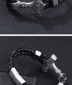 Detail of silver Mjolnir hammer pendant on black braided leather Viking bracelet