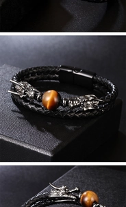 Detailed macro view of woven black leather bracelet with dragon heads and tiger eye stone
