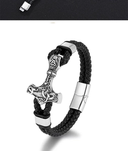 Macro detail of Nordic Viking Mjolnir charm and braided black leather strap with magnetic clasp