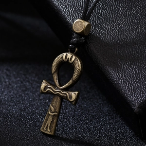 Vintage bronze Egyptian Ankh cross pendant with intricate engravings on black cord necklace