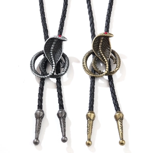 Vintage cobra bolo ties in antique silver and bronze finishes with black braided leather cords