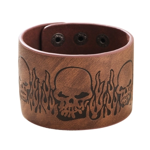 Men's brown leather wide cuff bracelet featuring embossed skull and flame punk patterns